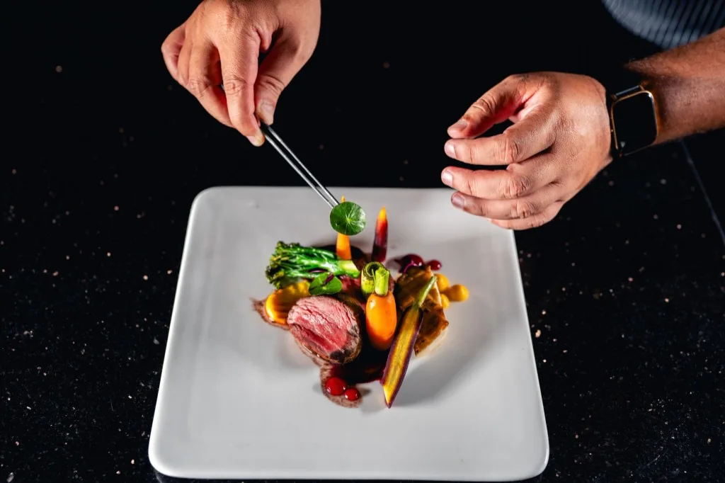 Chef plating finished restaurant dish